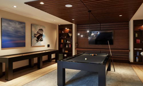a clubhouse room with a pool table and a tv on the wall