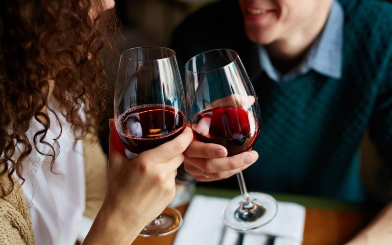 a couple of people holding wine glasses