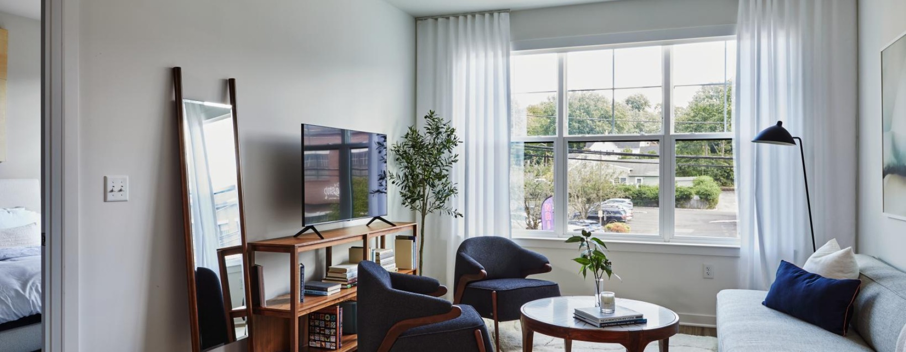 a living room with a couch, chairs and a tv