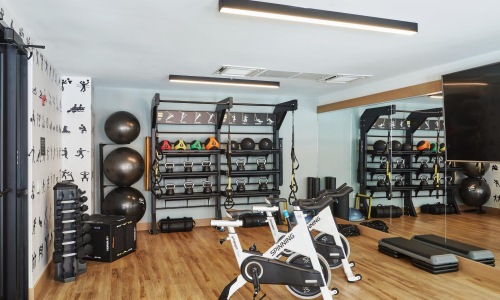 a room with exercise equipment and a mirror