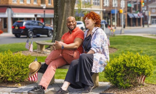 a man and woman sitting on a bench